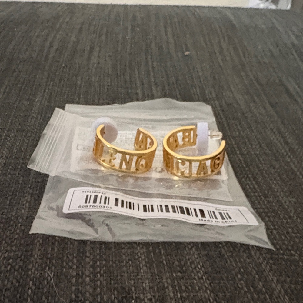 Gold Designer Women's earings reads BALENCIAGA